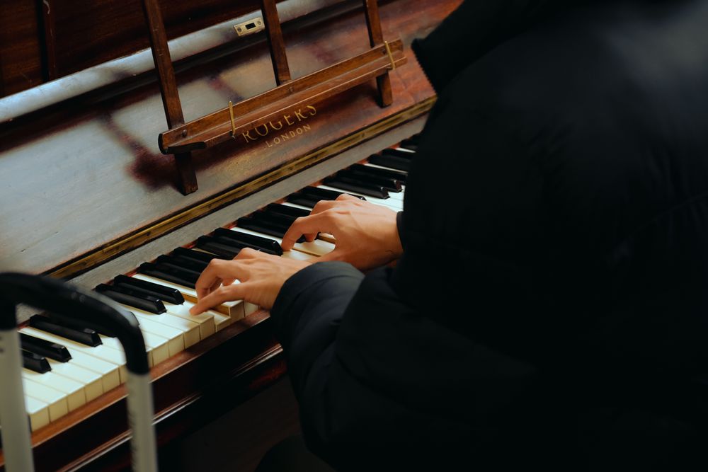Hands playing piano.