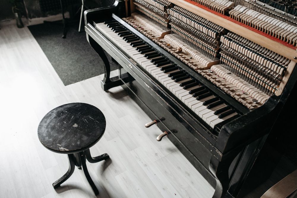 Black wooden piano and a stool.